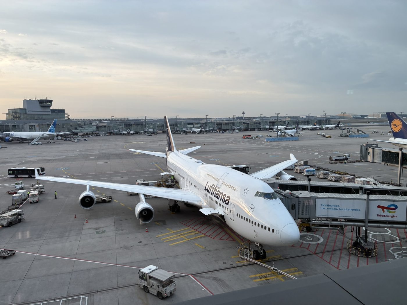 A Boeing 747 parked at the gate on an airport tarmac