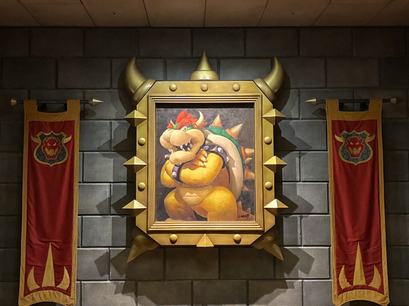 Bowser artwork displayed between banners at a gaming venue