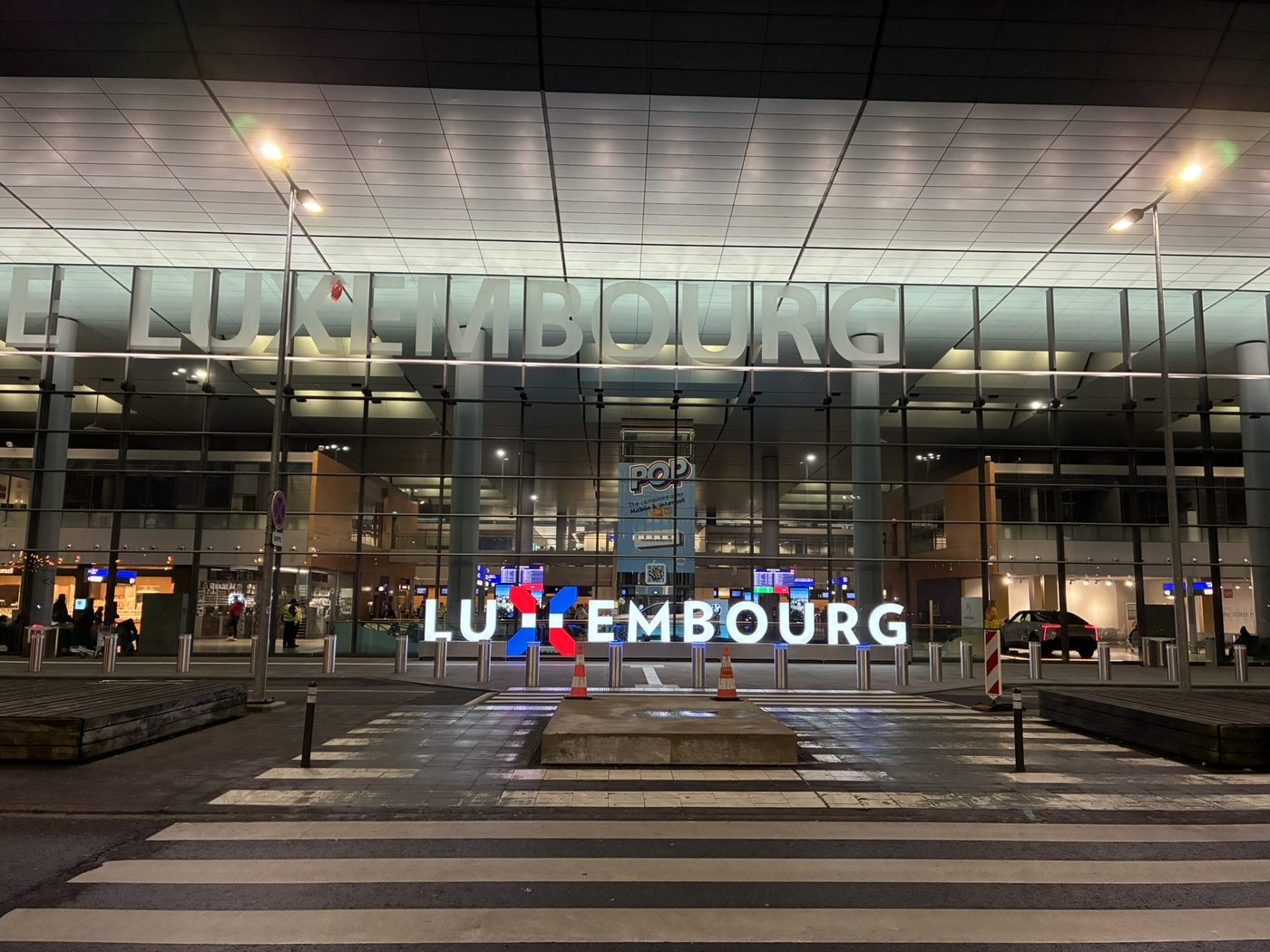 A modern building in Luxembourg City lit up at night