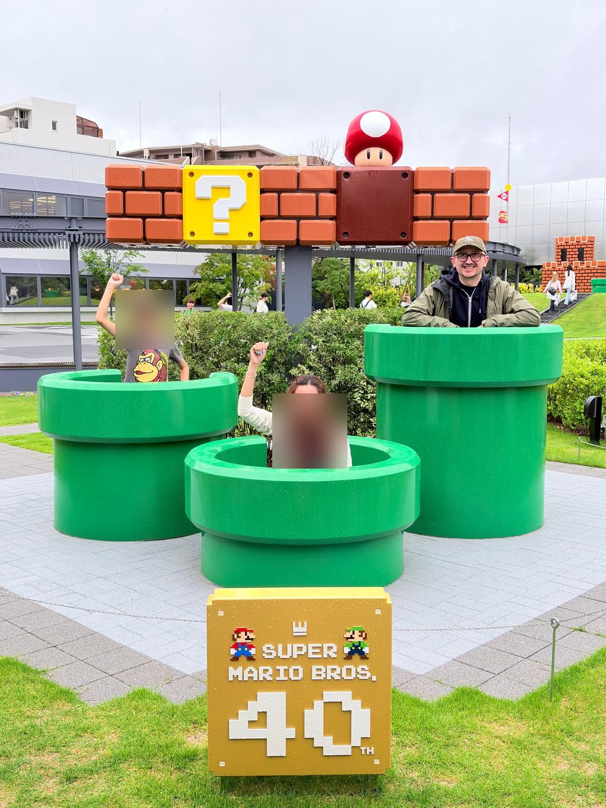 Posing at a giant Super Mario Bros pipes display for the franchise's 40th anniversary