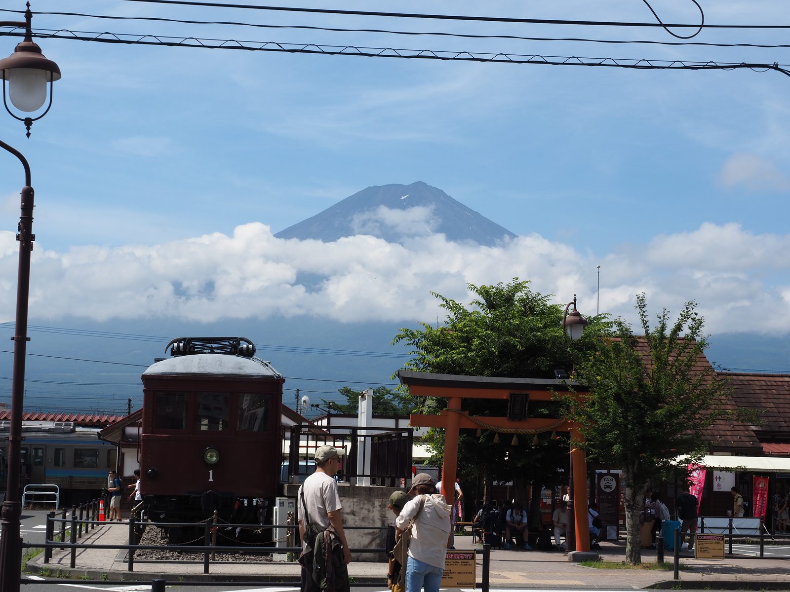 Mount Fuji seen in the distance from a train station platform in Japan