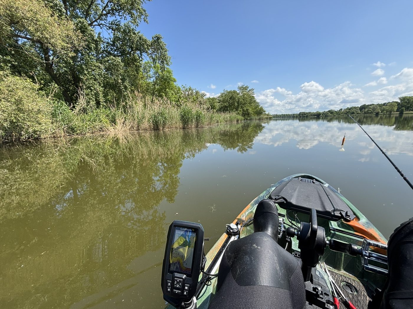 View of the river from a small boat with fishing gear on board